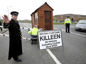 Protesters dressed as customs officials stop a car as they set up a mock customs post in a stunt during a protest against any border between Ireland and Northern Ireland because of Brexit gather at the Carrickcarnan border between Newry in Norther Ireland and Dundalk in the Irish Republic on March 30, 2019. (PAUL FAITH/AFP/Getty Images)