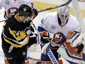 Penguins' Bryan Rust (left) can't get to a rebound off Islanders goaltender Robin Lehner during the first period in Game 4 of an NHL first-round playoff series in Pittsburgh, Tuesday, April 16, 2019.