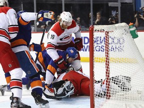 Matt Martin of the New York Islanders is stopped by Dougie Hamilton and Petr Mrazek of the Carolina Hurricanes during the second period in Game 2 of the Eastern Conference Second Round during the 2019 NHL Stanley Cup Playoffs at the Barclays Center on April 28, 2019 in New York City.