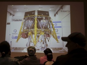 People watch the live broadcast of the SpaceIL spacecraft as it lost contact with Earth in Netanya, Israel, Thursday, April 11, 2019.