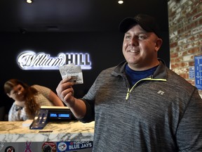 James Adducci of Wisconsin stands with his winning tickets at the William Hill Sports Book at SLS Las Vegas Hotel on April 15, 2019 in Las Vegas, Nevada. (David Becker/Getty Images for William Hill US)