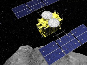 In this computer graphics image released by the Japan Aerospace Exploration Agency (JAXA), the Hayabusa2 spacecraft is seen above on the asteroid Ryugu. (ISAS/JAXA via AP)