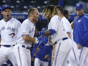 Blue Jays Brandon Drury 3B is congratulated by Blue Jays Vlad Guerrero Jr. after hitting a two-run homer In the ninth inning on Friday night.