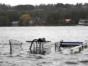 A patio set normally overlooking the Ottawa River is consumed by its waters at a home in the Ottawa community of Constance Bay as flooding continues to affect the region, on Saturday, April 27, 2019. THE CANADIAN PRESS/Justin Tang