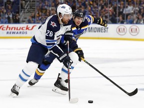 Winnipeg Jets right wing Blake Wheeler (26) and St. Louis Blues left wing Alexander Steen (20) fight for the puck during the first period in Game 4 of an NHL first-round hockey playoff series, Tuesday, April 16, 2019, in St. Louis.
