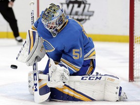 St. Louis Blues goaltender Jordan Binnington (50) makes a stick save against the Tampa Bay Lightning in St. Louis on March 23, 2019. (THE CANADIAN PRESS/AP, Tom Gannam)