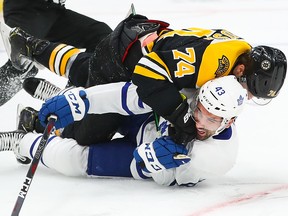 Jake DeBrusk of the Boston Bruins lands a punch on Nazem Kadri of the Toronto Maple Leafs in Game 2 of the Eastern Conference First Round during the 2019 NHL Stanley Cup Playoffs at TD Garden on April 13, 2019 in Boston.