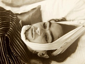 This 1940 photo provided by Sotheby's shows artist Frida Kahlo with her head suspended by straps.