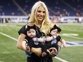 In this Sept. 24, 2017, file photo, Kelly Stafford, wife of Detroit Lions quarterback Matthew Stafford, holds the couple's twins Sawyer, left, and Chandler before a game against the Atlanta Falcons, in Detroit. (AP Photo/Rick Osentoski, File)