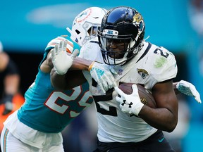 Leonard Fournette of the Jacksonville Jaguars tries to avoid the tackle of Minkah Fitzpatrick of the Miami Dolphins at Hard Rock Stadium on December 23, 2018 in Miami. (Michael Reaves/Getty Images)