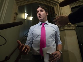 Prime Minister Justin Trudeau speaks with the media as he makes his way to caucus in the West Block, Wednesday, April 10, 2019 in Ottawa.
