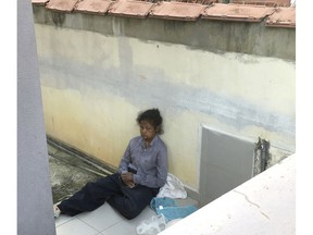 In this Feb. 10, 2018, file photo, Indonesian housemaid Adelina Lisao sits on the porch in Bukit Mertajam, near Penang, Malaysia.