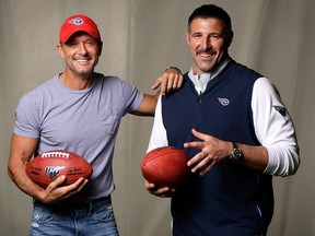 In this April 18, 2019, photo, country music star Tim McGraw, left, poses with Tennessee Titans head coach Mike Vrabel in Nashville, Tenn.