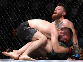 Khabib Nurmagomedov holds down Conor McGregor during their UFC lightweight championship bout at  UFC 229 inside T-Mobile Arena on October 6, 2018 in Las Vegas. (Harry How/Getty Images)