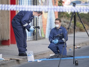 Forensic police examine items at the scene of a multiple shooting outside Love Machine nightclub in Melbourne, Sunday, April 14, 2019. (Ellen Smith/AAP Image via AP)