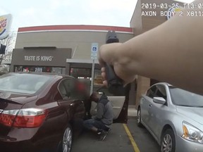 In this frame grab from a Charlotte-Mecklenburg Police Department officer body camera released Monday, April 15, 2019, shows two officers approaching 27-year-old Danquirs Napoleon Franklin outside a Burger King on March 29, 2019 in Charlotte, N.C.