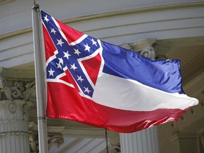 In this June 23, 2015 file photo, the state flag of Mississippi flies at the Governor's Mansion in Jackson, Miss. (AP Photo/Rogelio V. Solis, File)