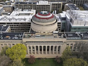 This Sunday, April 28, 2019 photo provided by Raymond Huffman shows Massachusetts Institute of Technology's signature Great Dome draped with a giant cloth version of Captain America's red, white and blue shield, in Cambridge, Mass. (Raymond Huffman via AP)