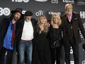 Inductee Stevie Nicks, center, poses with other members of Fleetwood Mac, from left, Mike Campbell, John McVie, Christine McVie and Mick Fleetwood at the Rock & Roll Hall of Fame induction ceremony in New York on March 29, 2019. Fleetwood Mac is postpoing four Canadian tour dates as Stevie Nicks deals with the flu. A statement issued by the band says concerts in Toronto (April 8), Winnipeg (April 11), Edmonton (April 13) and Calgary (May 2) will all be rescheduled, in addition to a number of U.S. dates.