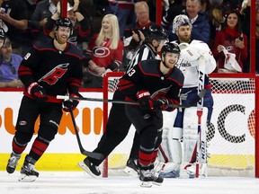 Hurricanes' Warren Foegele (centre) celebrates his goal with Dougie Hamilton (left) during the first period of Game 4 of the team's NHL first-round playoff series against the Capitals in Raleigh, N.C, Thursday, April 18, 2019,