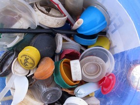 Some of the plastic caps collected by volunteers during cleanups of New Jersey's beaches last year are displayed Tuesday, April 2, 2019, in Sandy Hook, N.J.