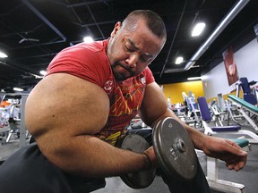 In this Nov. 16, 2012, file photo, Egyptian body builder Moustafa Ismail lifts free weights during his daily workout in Milford, Mass. (AP Photo/Stephan Savoia, File)