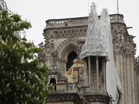 A net covers parts of Notre Dame cathedral in Paris, Tuesday, April 23, 2019.