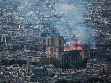 Smoke and flames rise during a fire at the landmark Notre Dame Cathedral in central Paris on April 15, 2019.