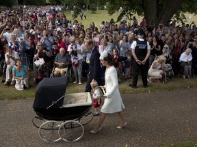 This July 5, 2015 file photo shows Britain's Prince William, Kate the Duchess of Cambridge, with son Prince George and daughter Princess Charlotte in a pram as they arrive for Charlotte's Christening at St. Mary Magdalene Church in Sandringham, England.