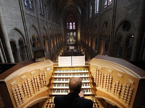 In this Thursday, May 2, 2013 file photo, Philippe Lefebvre, 64, plays the organ at Notre Dame cathedral in Paris. (AP Photo/Christophe Ena, file)