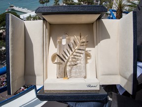 A person holds up a box containing the Palme d'Or award, which will be presented on Sunday, at the 68th international film festival, Cannes, southern France, Saturday, May 23, 2015.