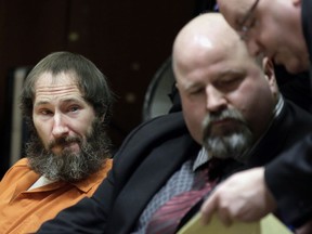 In this March 8, 2019 file photo, Johnny Bobbitt, left, looks on as his attorney John Keesler and Assistant Prosecutor Andrew McDonnell, right, talk while appearing before Superior Court Judge Christopher Garrenger at the Burlington County Courthouse in Mount Holly, N.J. Bobbitt, who pleaded guilty to taking part in a $400,000 GoFundMe scam with a New Jersey couple, will face sentencing on Friday, April 12.