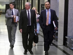 Attorneys Jack Goldberger, centre, Alex Spiro, left, and William Burck, the defence team for New England Patriots owner Robert Kraft, make their way to Courtroom 2E at the Palm Beach County Courthouse, Friday, April 12, 2019, in West Palm Beach, Fla.