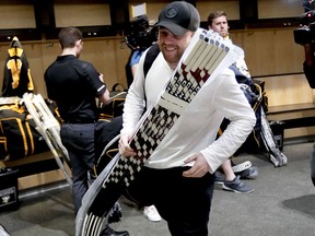 Pittsburgh Penguins forward Phil Kessel carries sticks and equipment from the practice facility locker room before leaving for the off season two days after being swept by the New York Islanders Thursday, April 18, 2019. (AP Photo/Keith Srakocic)