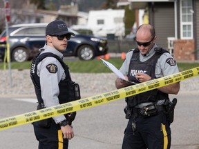 RCMP officers work outside a crime scene in Penticton, B.C., on Monday, April 15, 2019.