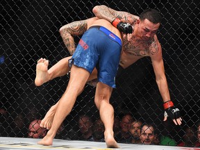 Dustin Poirier takes down Max Holloway during the UFC 236 event at State Farm Arena on April 13, 2019 in Atlanta, Ga.