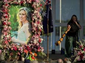 In this Aug. 11, 2017, file photo, Johanna Morrow plays the didgeridoo during a memorial service for Justine Ruszczyk Damond at Lake Harriet in Minneapolis.