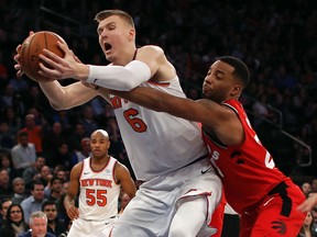 Toronto Raptors forward Norman Powell (24) tries to strip the ball from New York Knicks forward Kristaps Porzingis (6) Wednesday, Nov. 22, 2017, in New York. (AP Photo/Julie Jacobson)