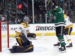 Predators goaltender Pekka Rinne watches as Stars left wing Jamie Benn (right) celebrates a goal by Roope Hintz (not shown) during the first period of Game 4 in a first round NHL playoff series in Dallas, Wednesday, April 17, 2019.