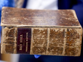 FBI supervisory special agent Shawn Brokos shows the recovered 1615 Breeches Edition Bible during a news conference, Thursday, April 25, 2019, in Pittsburgh. The Bible was stolen from the Carnegie Library in Pittsburgh in the 1990's. It was traced to the American Pilgrim Museum in Leiden, Netherlands.