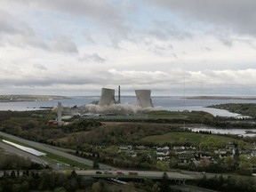In this image from video provided by Grace Barker Health, the two 500-foot cooling towers of the former Brayton Point Station in Somerset, Mass., are demolished with explosives. The plant had burned coal since 1963. By the time it stopped producing power in 2017, it was the last coal-fired plant in Massachusetts.