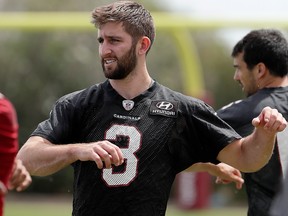 Then-Arizona Cardinals quarterback Josh Rosen stretches during an organized NFL team activity Tuesday, April 23, 2019, in Tempe, Ariz.