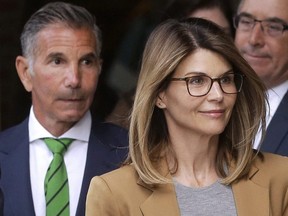 Lori Loughlin and husband Mossimo Giannulli, left, depart federal court in Boston after facing charges in a nationwide college admissions bribery scandal.