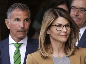 Lori Loughlin and husband Mossimo Giannulli, left, depart federal court in Boston after facing charges in a nationwide college admissions bribery scandal. She blames him.