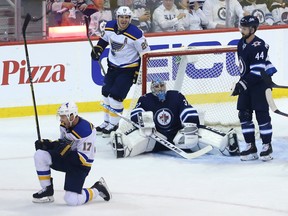 St. Louis Blues forward Jaden Schwartz (left) celebrates his game-winning goal on Winnipeg Jets goaltender Connor Hellebuyck Thursday night. (Kevin King/Winnipeg Sun)