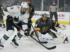 Vegas Golden Knights goaltender Marc-Andre Fleury, right, blocks a shot beside San Jose Sharks left wing Evander Kane during the first period of Game 4 of a first-round NHL hockey playoff series Tuesday, April 16, 2019, in Las Vegas.