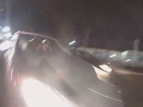 Body camera footage from a Burlington Township police officer shows the moment a car sideswipes the officer's car in New Jersey. (Burlington Township Police Department/Facebook screengrab)