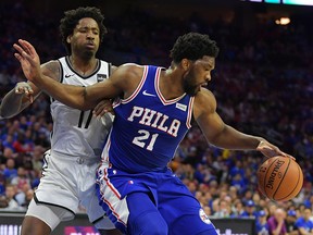 Joel Embiid of the Philadelphia 76ers tries to drive to the net on Ed Davis of the Brooklyn Nets during Game 1 of the first round of the NBA playoffs at Wells Fargo Center on April 13, 2019 in Philadelphia. (Drew Hallowell/Getty Images)