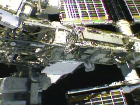 In this photo provided by NASA, NASA astronaut Anne McClain works outside the International Space Station, Monday, April 8, 2019. McClain and Canadian astronaut David Saint-Jacques got an early start Monday morning as they tackled battery and cable work outside the International Space Station. It's the third spacewalk in just 2 ½ weeks for the station crew.  (NASA via AP) ORG XMIT: NYCD304