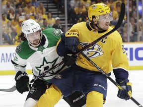 Stars center Matts Zuccarello (left) and Predators defenceman Roman Josi (right) vie for the puck during the first period in Game 1 of an NHL first-round playoff series Wednesday, April 10, 2019, in Nashville, Tenn.